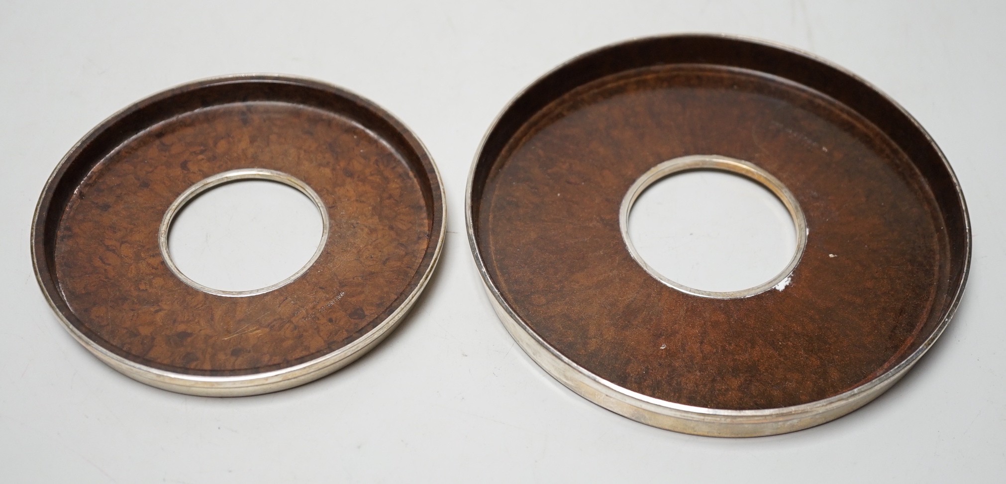Two 1930's graduated silver mounted faux walnut bottle coasters, Joseph Gloster Ltd. Birmingham, 1935/8, largest diameter 16cm.